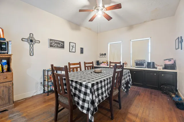 a view of a dining room with furniture and wooden floor