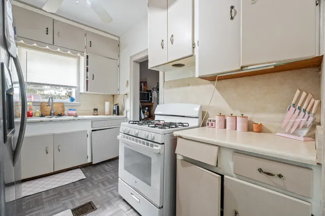 a kitchen with cabinets appliances and a counter top space
