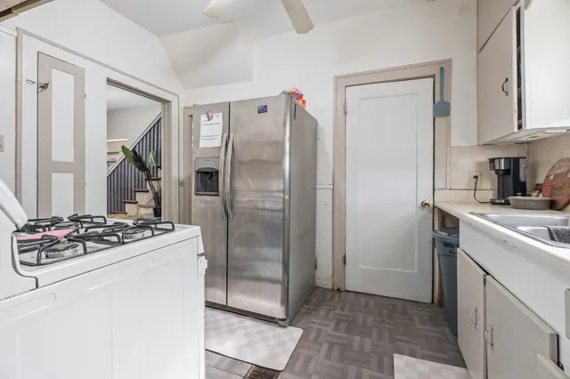 a kitchen with stainless steel appliances granite countertop a refrigerator and a stove