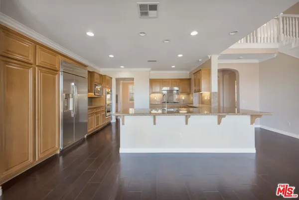 a kitchen with granite countertop white cabinets and a stove