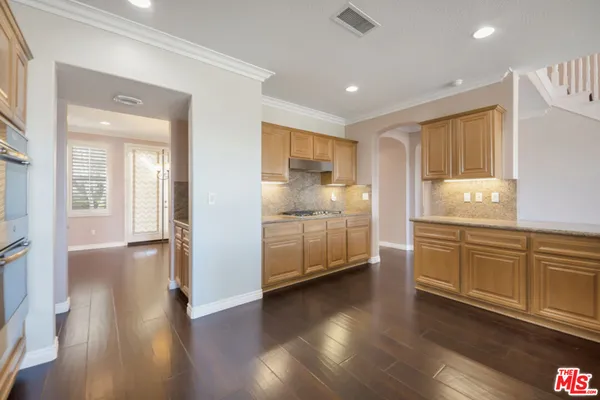 a view of an entryway with wooden floor