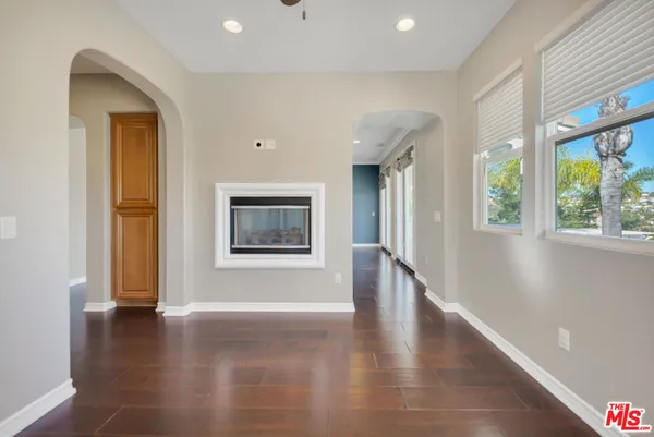 a bathroom with a granite countertop sink a mirror and a bathtub