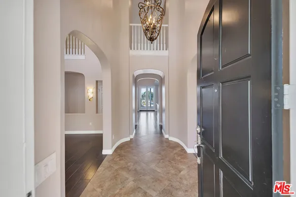 a view of a hallway with entryway wooden floor and front door