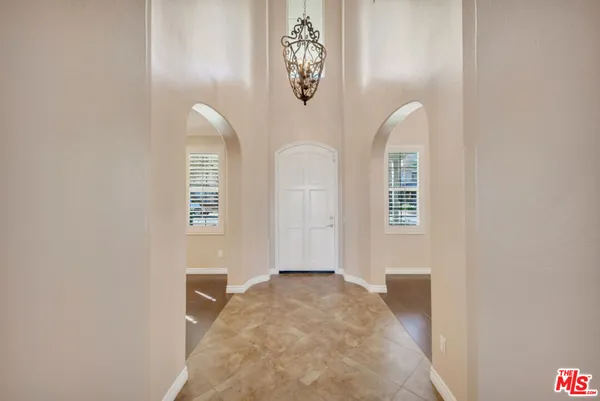 a view of a livingroom with wooden floor a fireplace and windows