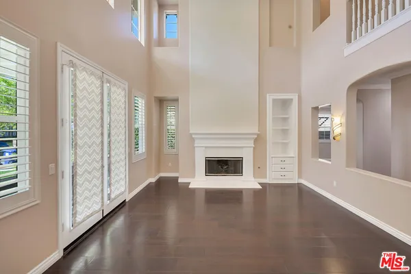 wooden floor in a hall with a window