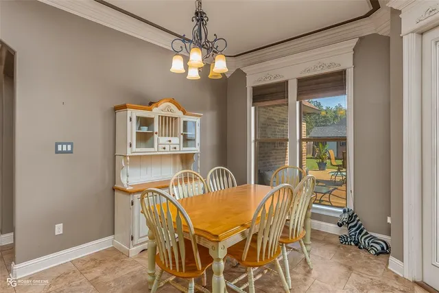 a view of a dining room with furniture and chandelier