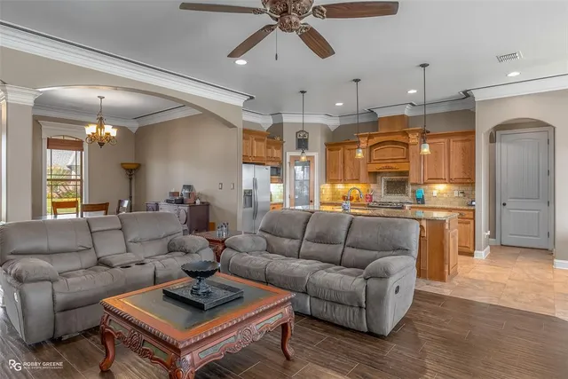 a living room with furniture a table and a flat screen tv
