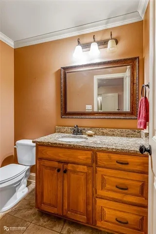 a spacious bedroom with a large bed and a chandelier