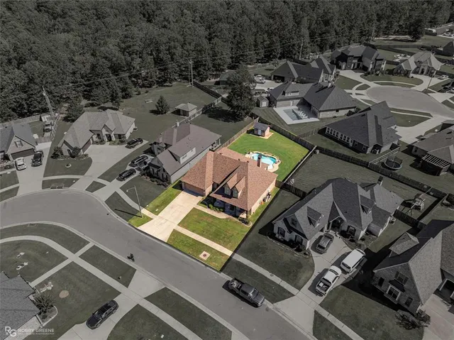 an aerial view of a swimming pool with lawn chairs and plants