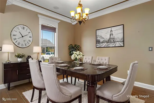 a view of a dining room with furniture wooden floor and a chandelier