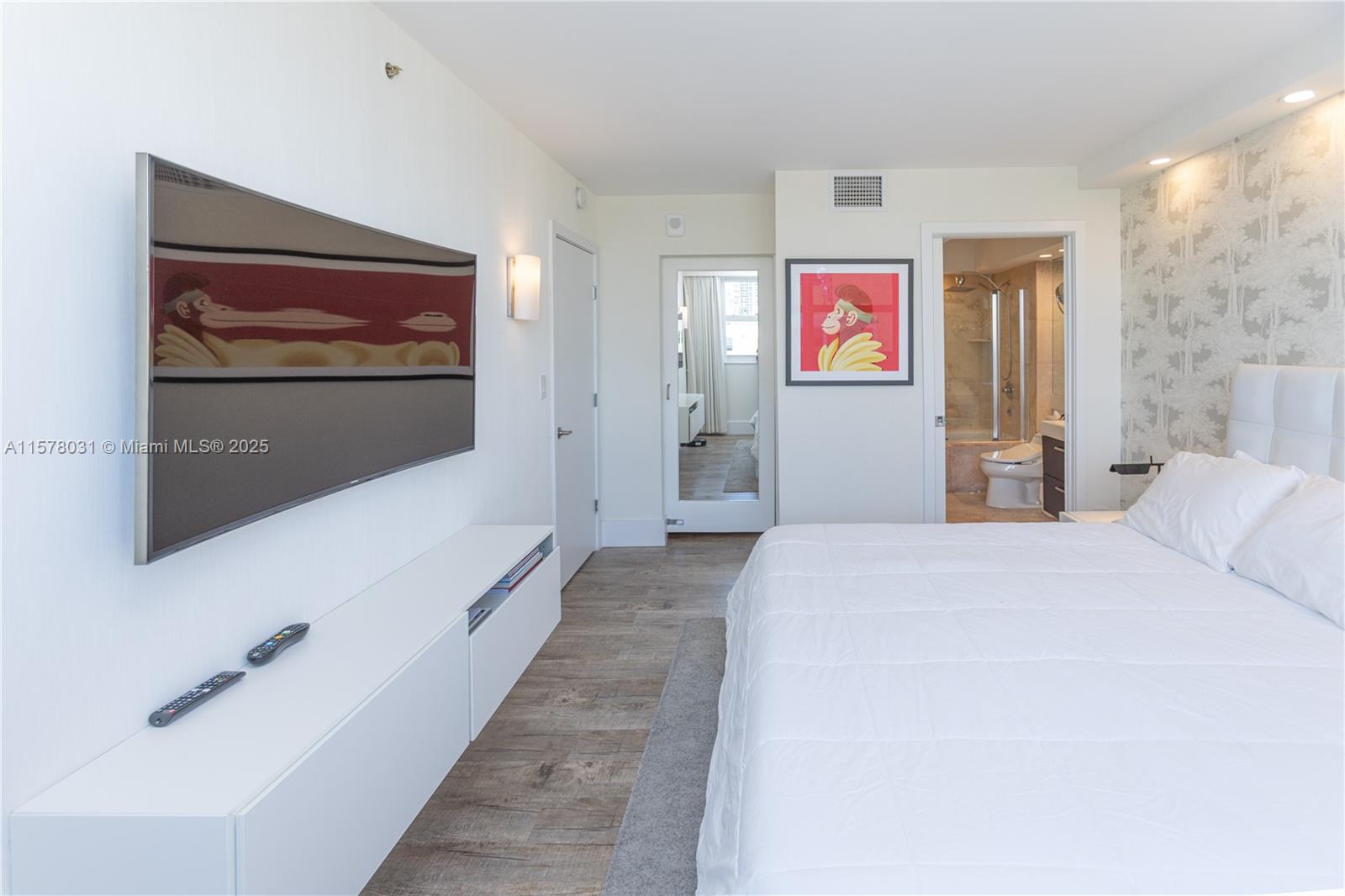 90 Alton Road, Unit 1411 Miami Beach, FL 33139 - Photo 11 of 36 a bedroom with a bed and a flat screen tv
