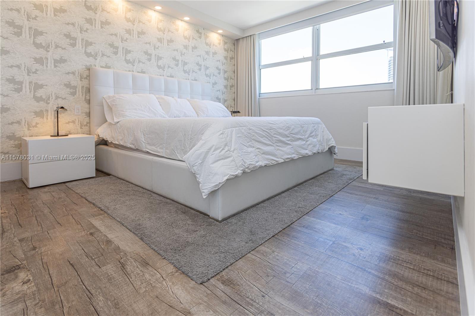 90 Alton Road, Unit 1411 Miami Beach, FL 33139 - Photo 12 of 36 a bedroom with a bed and a dresser next to a window
