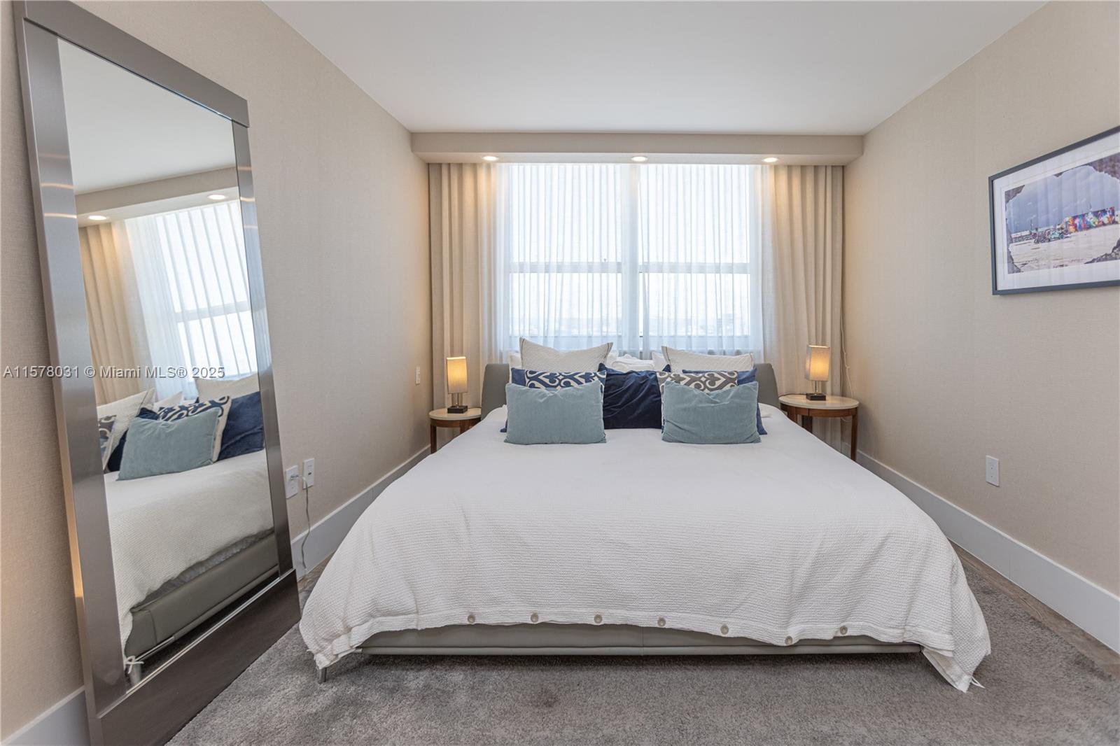 90 Alton Road, Unit 1411 Miami Beach, FL 33139 - Photo 13 of 36 a bedroom with a bed and window