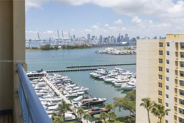 a view of a city with a lake and tall buildings