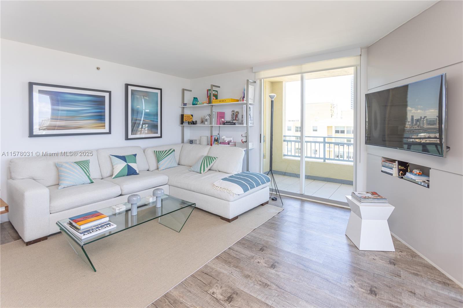 90 Alton Road, Unit 1411 Miami Beach, FL 33139 - Photo 3 of 36 a living room with furniture and a flat screen tv