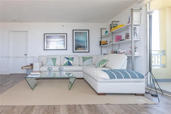 a living room with furniture and painting on the wall