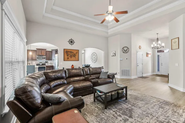 a living room with furniture ceiling fan and a rug