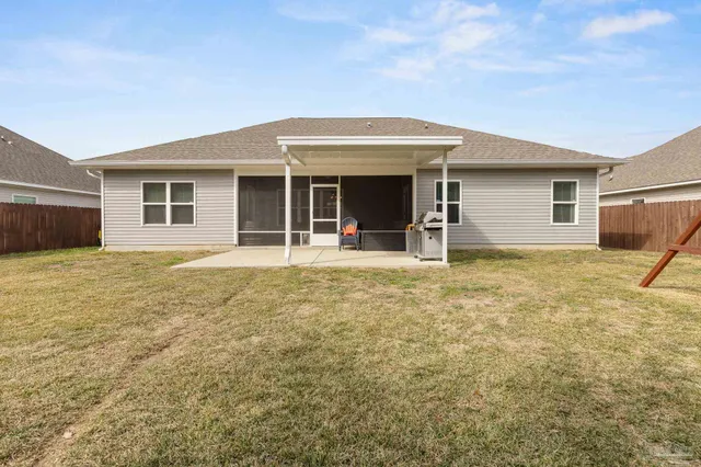 a view of a house with backyard and porch