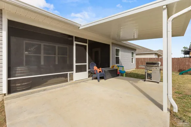 a view of a house with a large window and sitting area