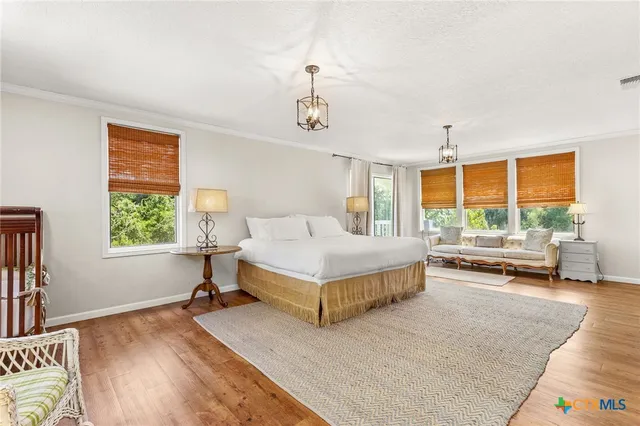 a bedroom with a bed and a large window