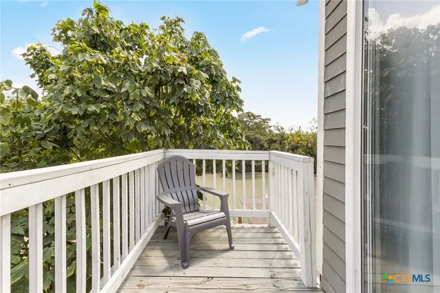 a view of balcony with wooden floor and fence