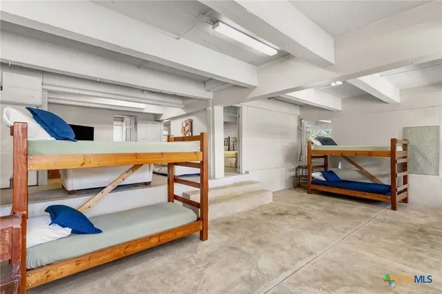 a bedroom with double bunk beds and a window