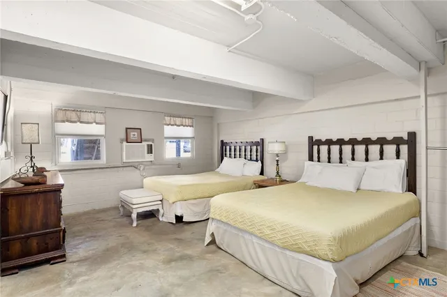 a bedroom with bed and a couch