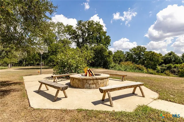 a swimming pool with outdoor seating and trees