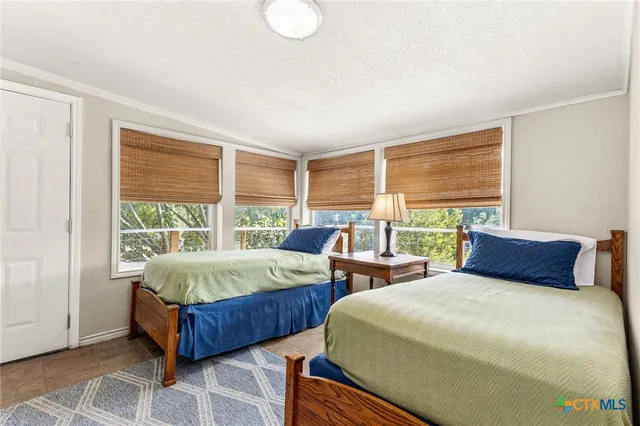 a bedroom with bed and glass window