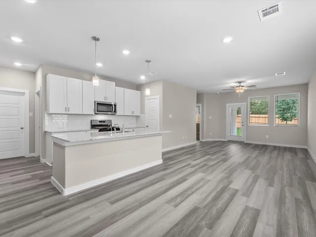 a view of kitchen with granite countertop cabinets and wooden floor