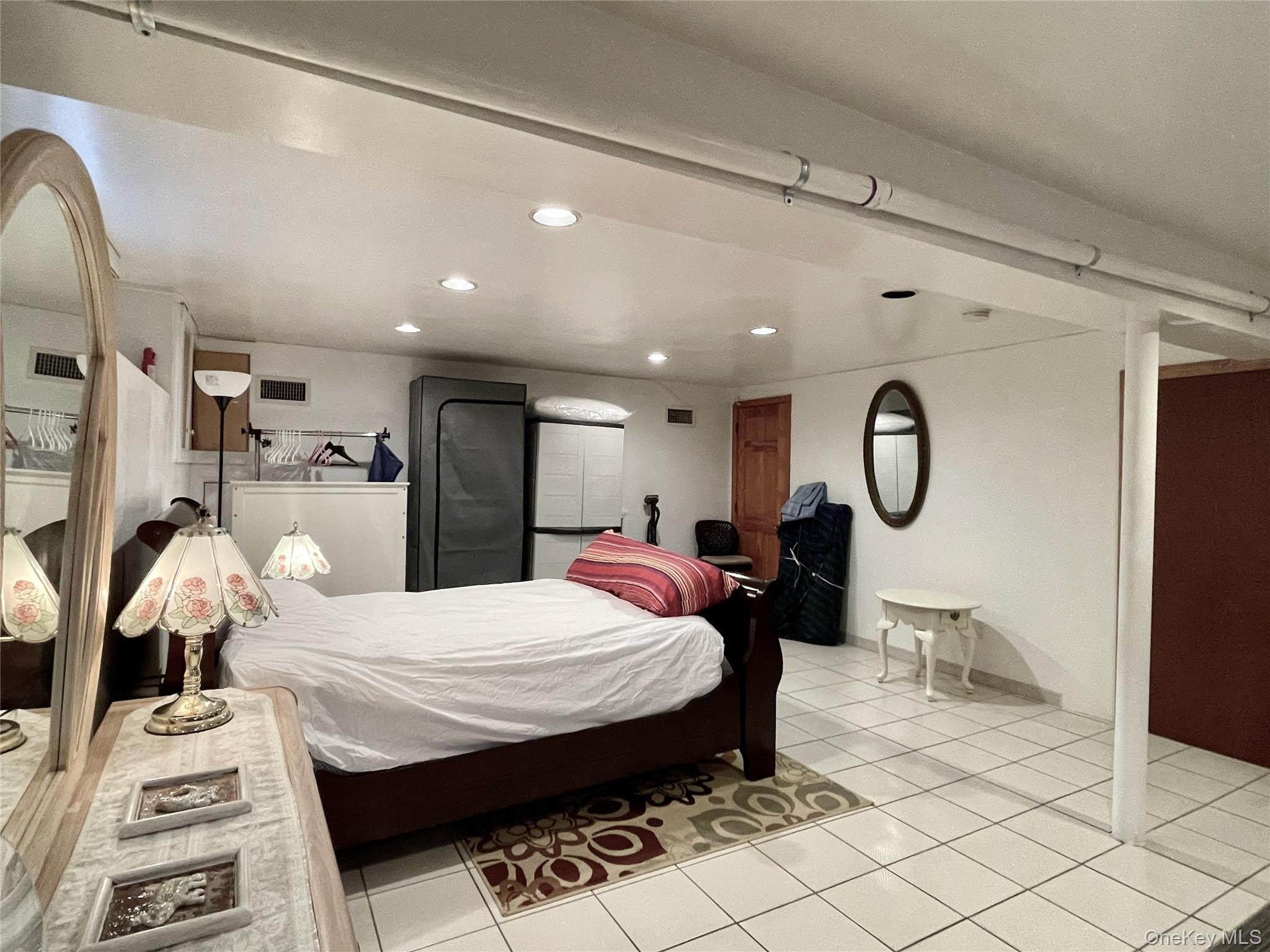 169 Old Mamaroneck Road, Unit B1 White Plains, NY 10605 - Photo 4 of 11 a bed room with a bed mirror and a desk