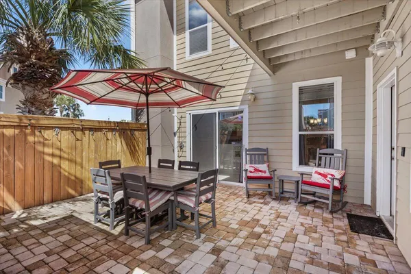 a backyard of a house with barbeque oven table and chairs
