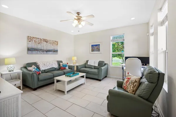 a living room with furniture and a chandelier