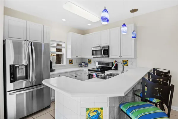 a kitchen with a sink appliances and cabinets