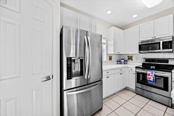a kitchen with stainless steel appliances granite countertop a refrigerator sink and stove