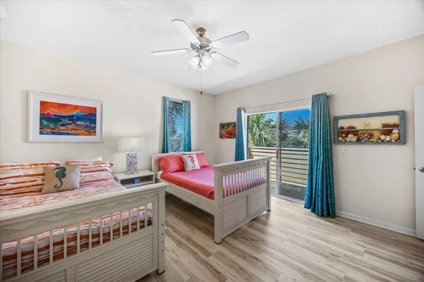 a bedroom with two beds and a chandelier