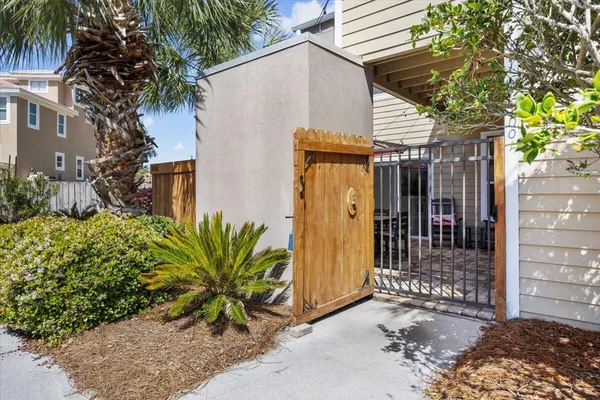 a view of a house with a potted plants and a large tree