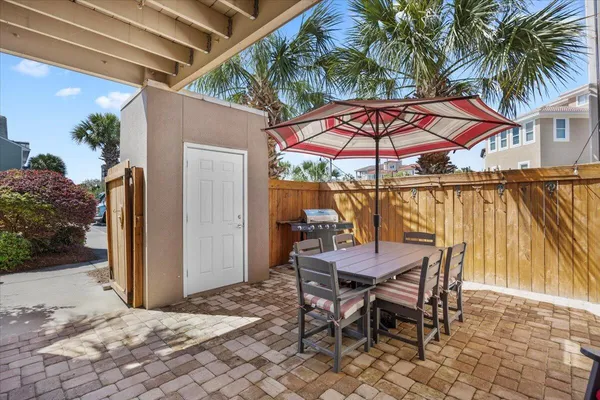 a patio with a yard table and chairs