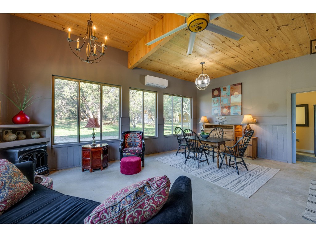 250 Caliche Road Wimberley, TX 78676 - Photo 15 of 40 a view of a dining room with furniture window and outside view