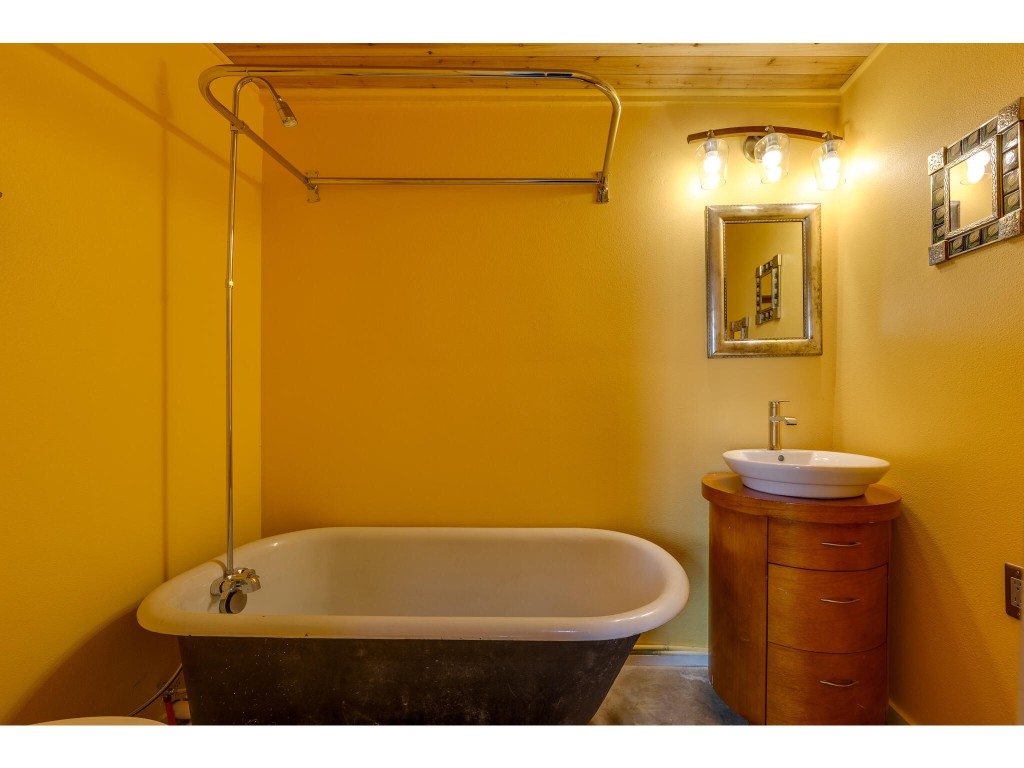 250 Caliche Road Wimberley, TX 78676 - Photo 18 of 40 a bathroom with a sink and a mirror