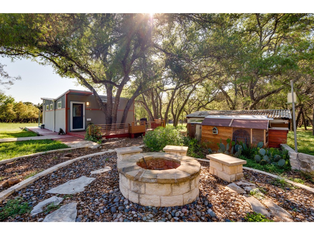 250 Caliche Road Wimberley, TX 78676 - Photo 19 of 40 a view of a house with backyard and sitting area