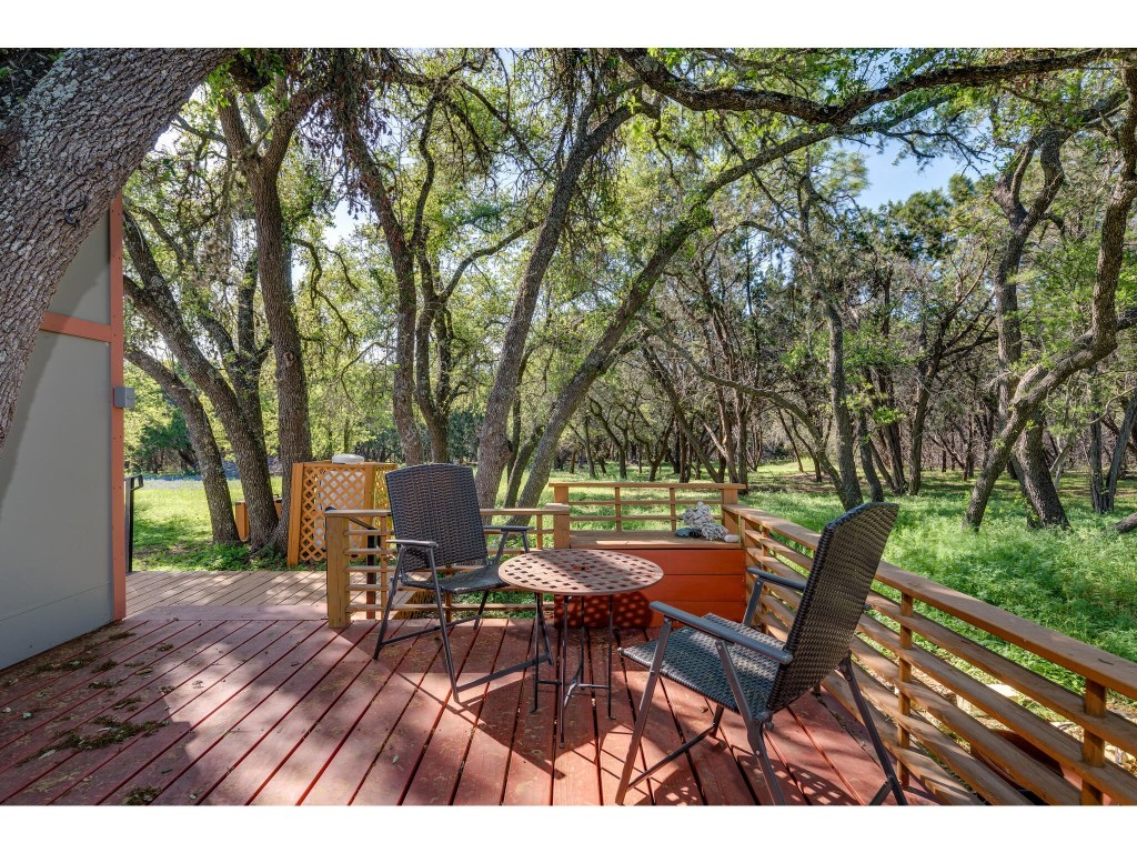 250 Caliche Road Wimberley, TX 78676 - Photo 22 of 40 a view of a chairs and table in patio
