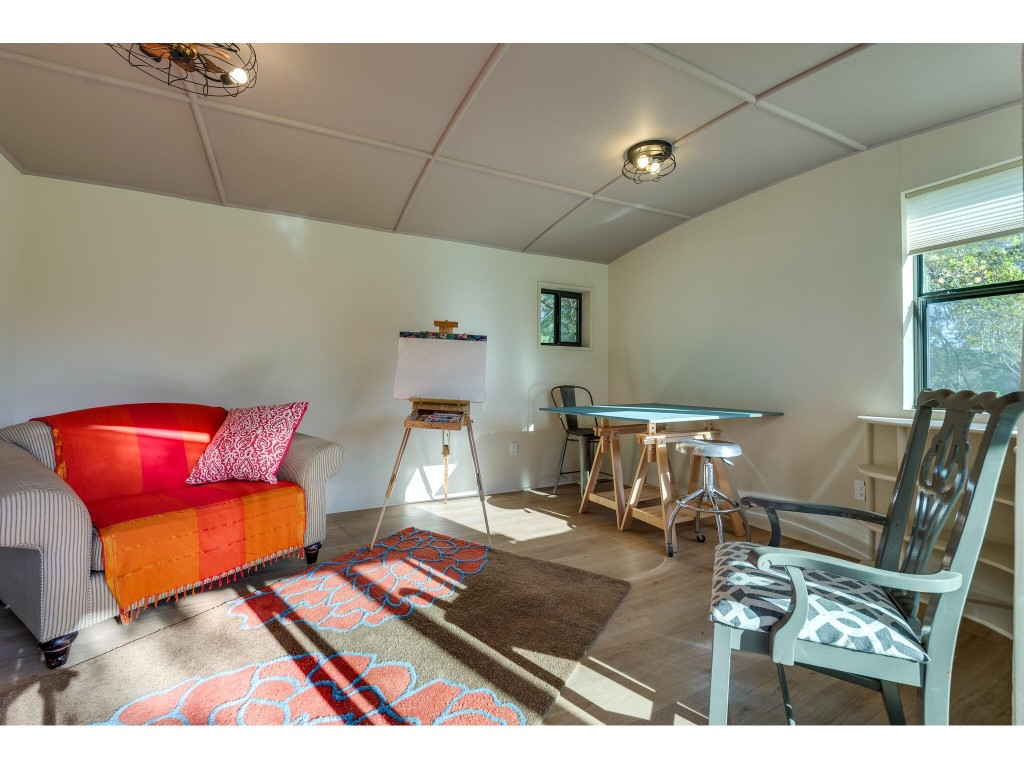 250 Caliche Road Wimberley, TX 78676 - Photo 40 of 40 a living room with furniture and a rug