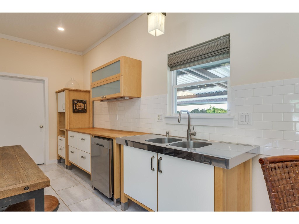 250 Caliche Road Wimberley, TX 78676 - Photo 7 of 40 a kitchen that has a sink a stove and a microwave
