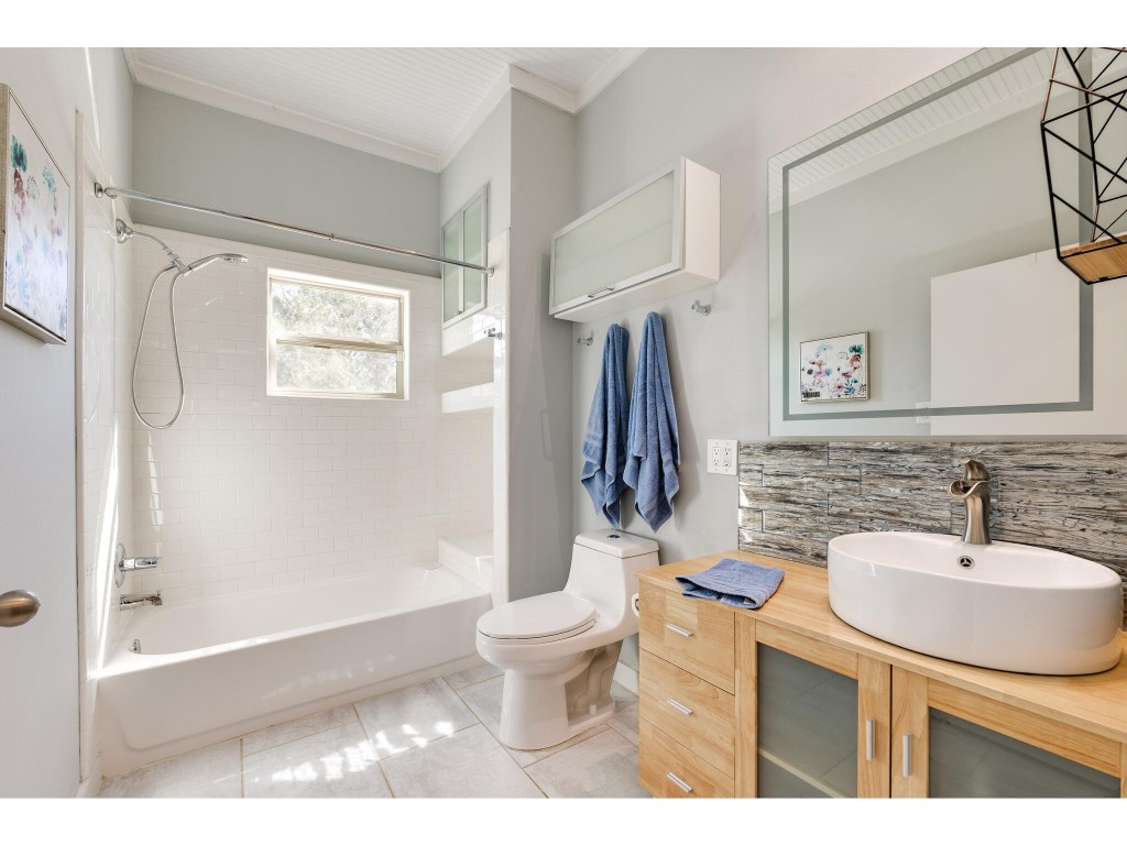 250 Caliche Road Wimberley, TX 78676 - Photo 10 of 40 a bathroom with a sink toilet and shower