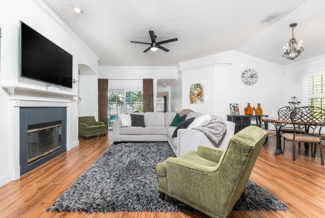a living room with furniture fireplace and flat screen tv