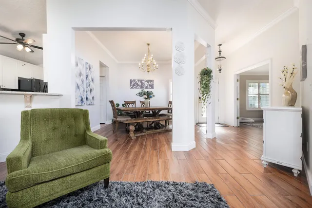 a living room with furniture and wooden floor