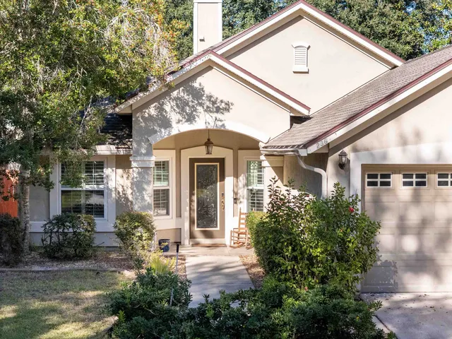 a front view of a house with garden