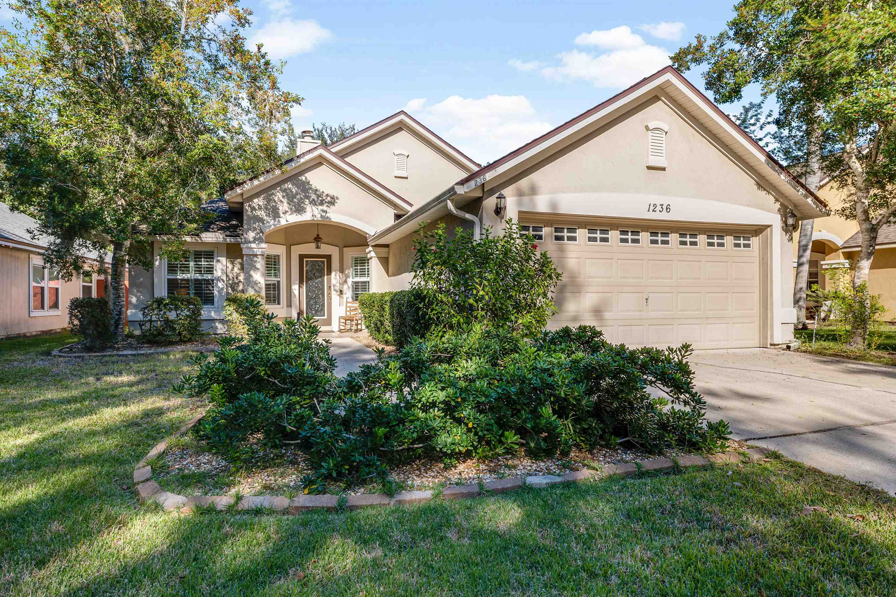 1236 Splendid Ravine Street St. Augustine, FL 32092 - Photo 24 of 47 a view of a white house with a big yard and potted plants
