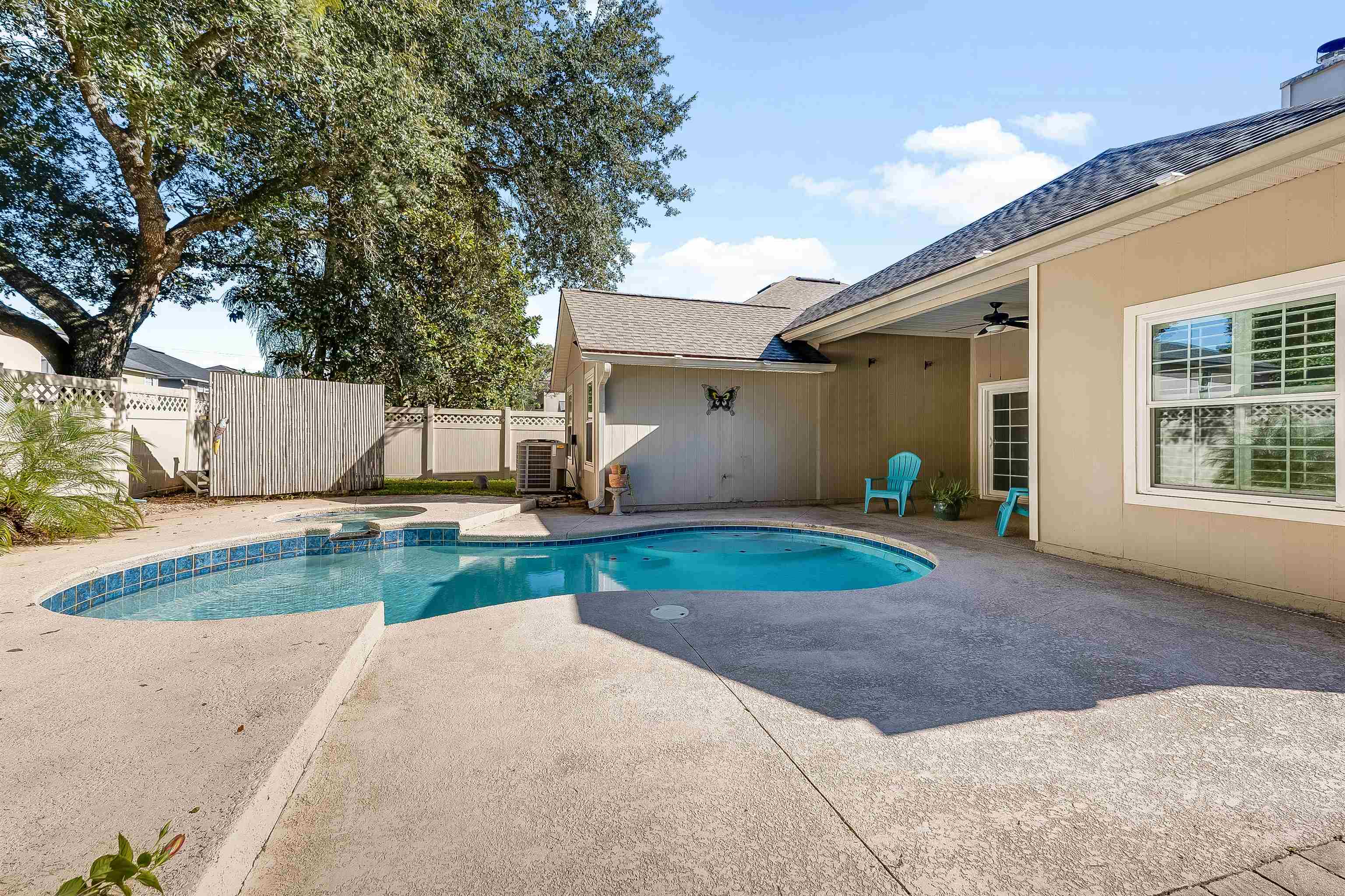1236 Splendid Ravine Street St. Augustine, FL 32092 - Photo 28 of 47 a view of a white house with a yard and a large tree